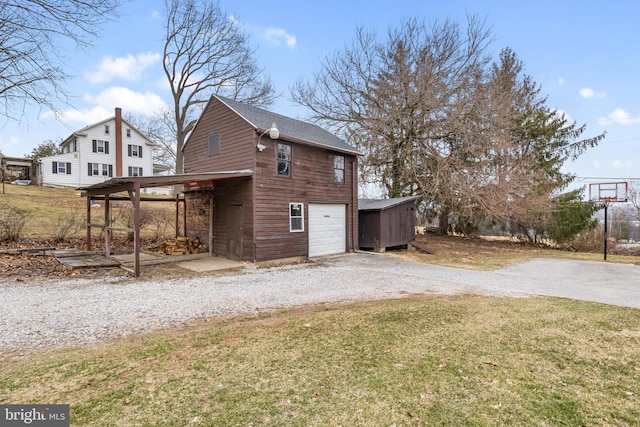 view of outbuilding featuring driveway and a garage