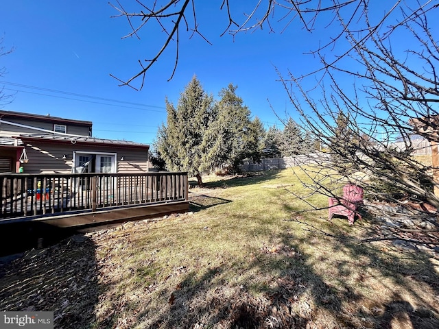 view of yard with a wooden deck and fence