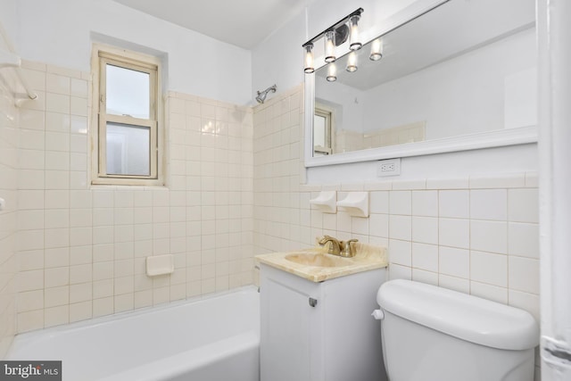 bathroom with vanity, tile walls, toilet, and tub / shower combination