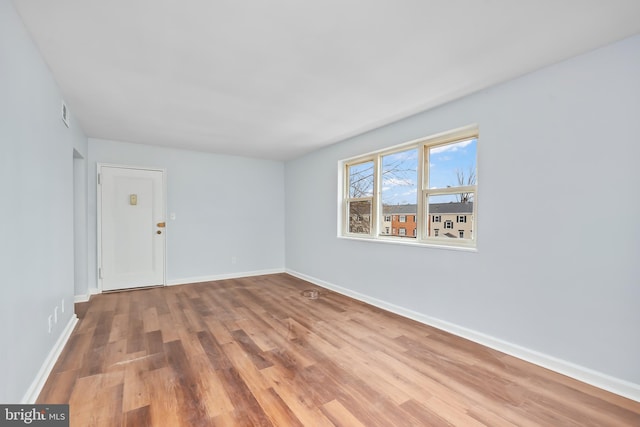 unfurnished room featuring wood finished floors and baseboards