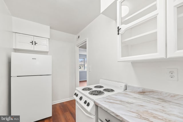 kitchen featuring visible vents, dark wood-type flooring, light stone counters, white appliances, and white cabinets