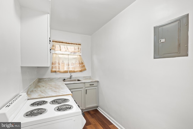 kitchen with electric panel, a sink, dark wood-style floors, white range with electric stovetop, and light countertops