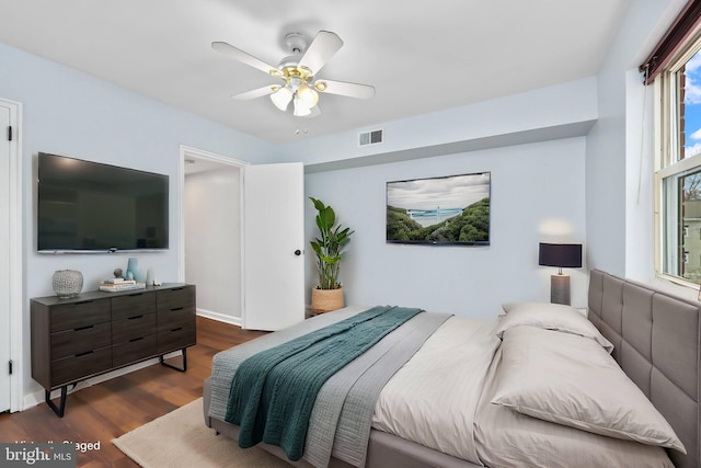 bedroom with dark wood-type flooring, visible vents, and ceiling fan