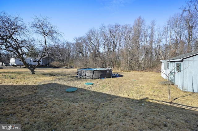 view of yard featuring an outdoor pool