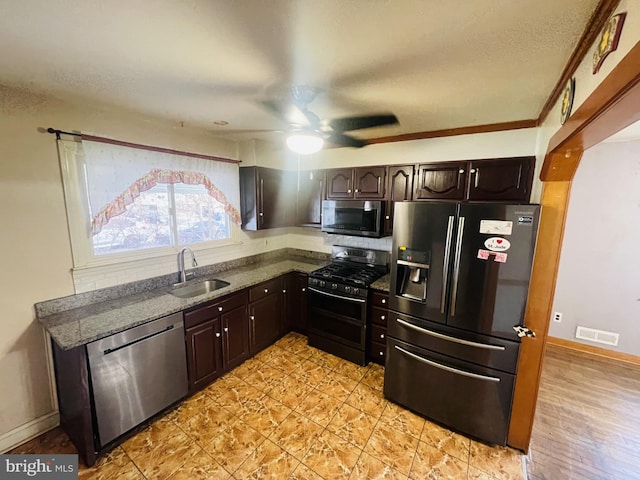 kitchen featuring dark brown cabinets, visible vents, appliances with stainless steel finishes, and a sink