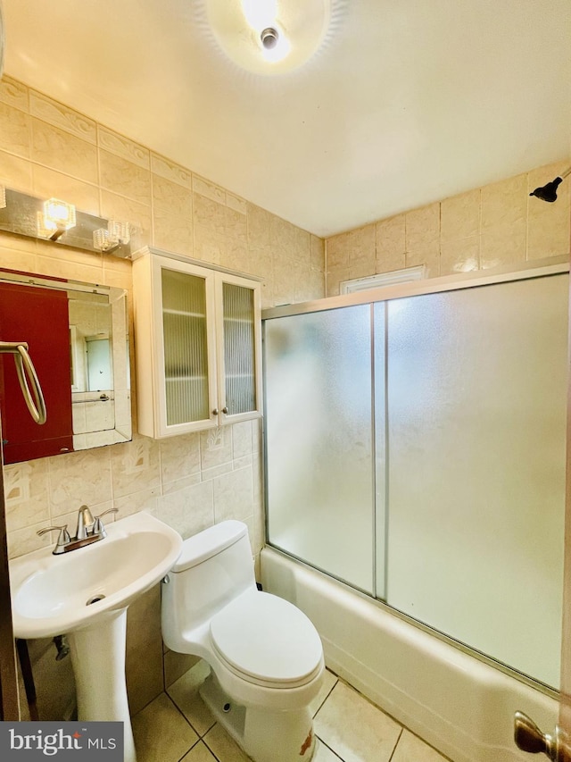 full bathroom featuring tile walls, tasteful backsplash, tile patterned floors, and enclosed tub / shower combo