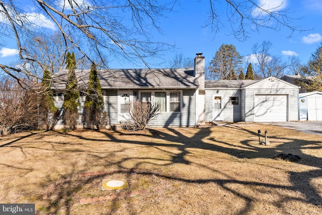 ranch-style house with a garage, driveway, a front yard, and a chimney