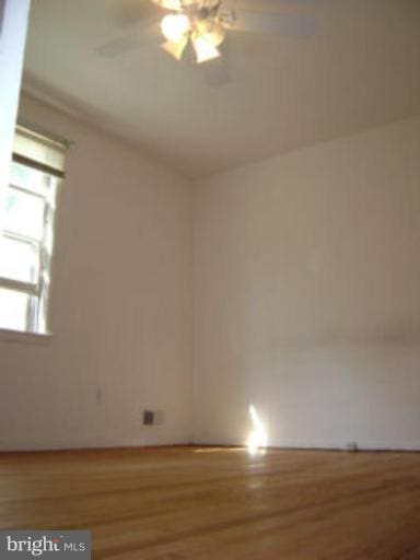 spare room featuring a ceiling fan and wood finished floors