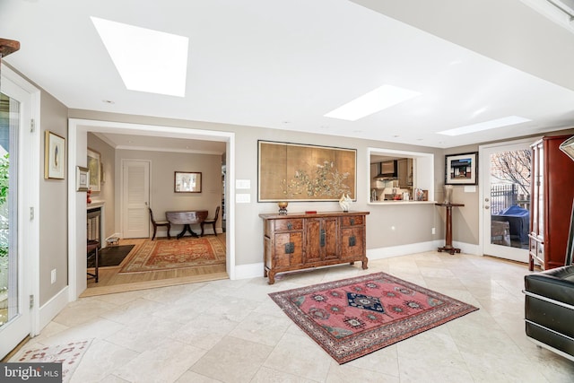 interior space featuring a wealth of natural light, a skylight, and baseboards