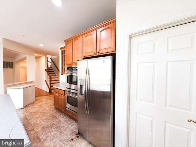 kitchen featuring glass insert cabinets, stainless steel appliances, light countertops, visible vents, and recessed lighting
