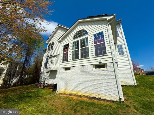 view of property exterior with a yard