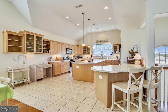 kitchen with visible vents, open shelves, an island with sink, stainless steel appliances, and light countertops