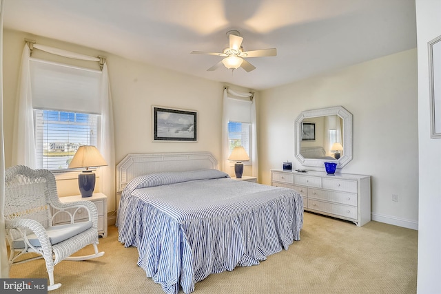 bedroom featuring light carpet, baseboards, and a ceiling fan