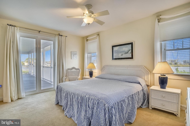 carpeted bedroom featuring access to exterior and a ceiling fan