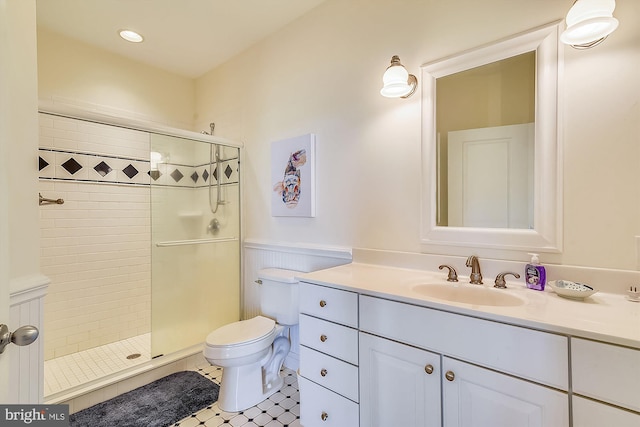 full bathroom featuring vanity, toilet, and a shower stall