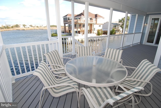 deck featuring a water view and outdoor dining space