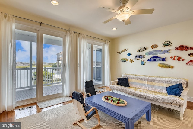 living room with wood finished floors, recessed lighting, and ceiling fan