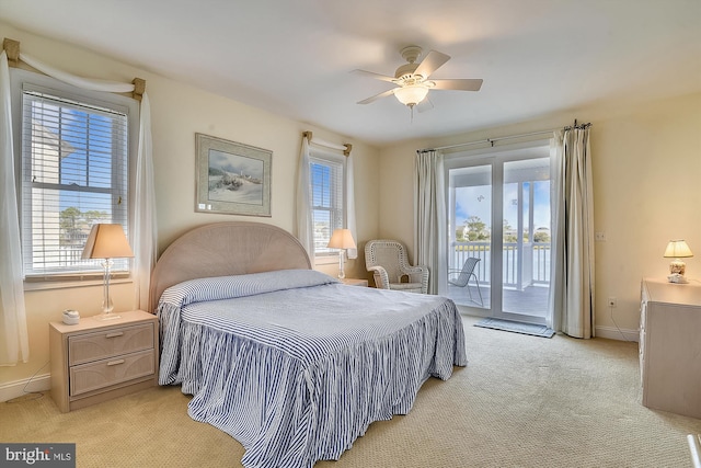 bedroom featuring baseboards, multiple windows, and access to exterior