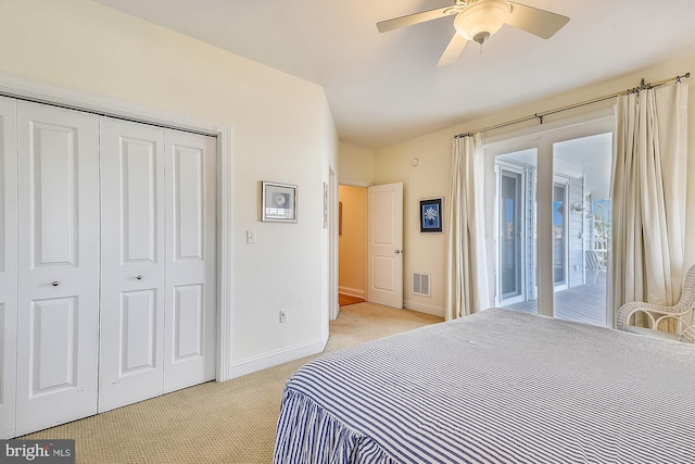 bedroom with visible vents, baseboards, light carpet, a closet, and access to outside