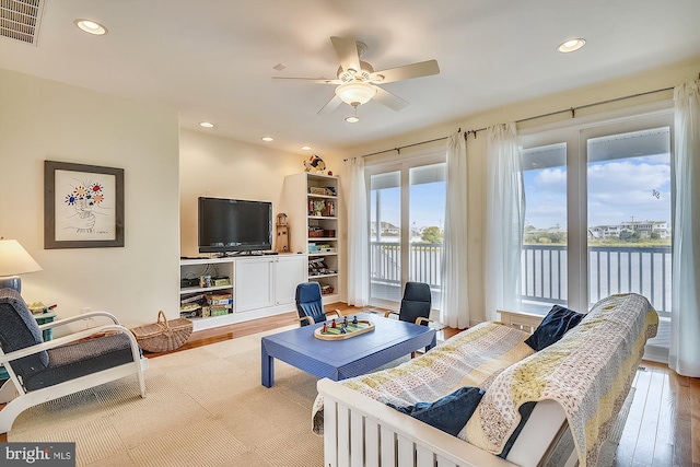 living area featuring a ceiling fan, recessed lighting, wood finished floors, and visible vents