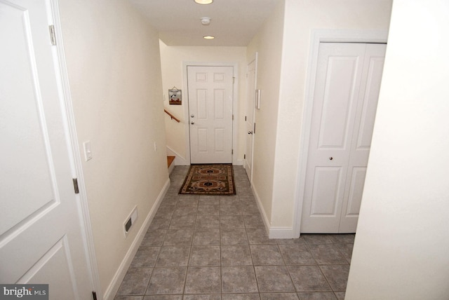 hallway featuring tile patterned floors, stairway, recessed lighting, and baseboards