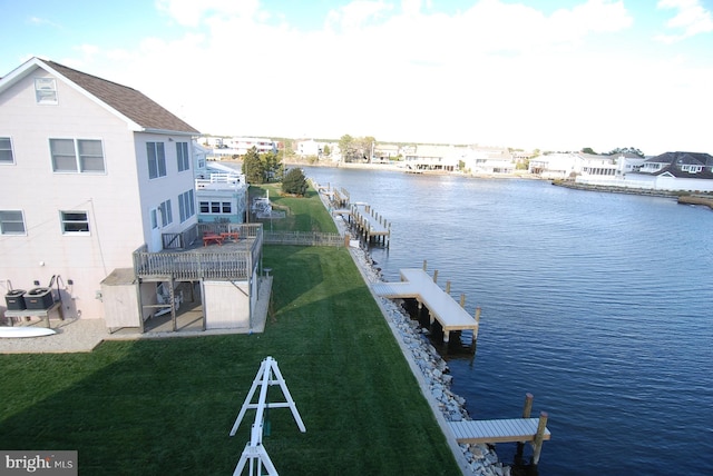 dock area featuring a lawn and a water view