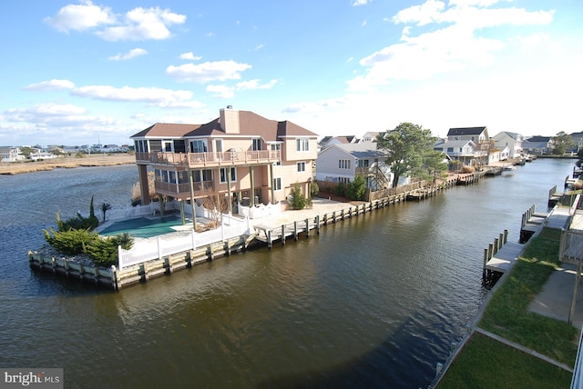 exterior space with a patio area, a residential view, a balcony, and a water view