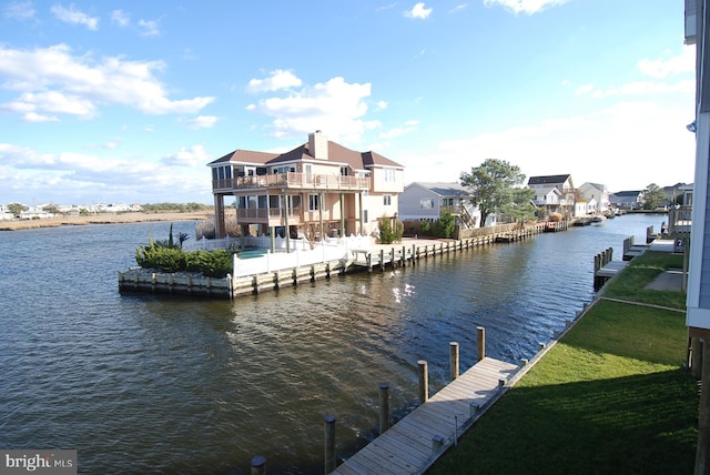 view of dock featuring a water view and a lawn