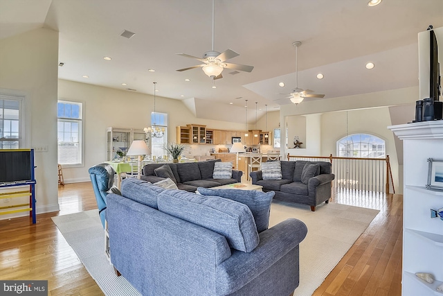 living room featuring light wood finished floors, a chandelier, recessed lighting, and high vaulted ceiling