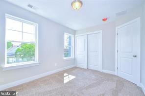 unfurnished bedroom featuring a closet, carpet flooring, and baseboards