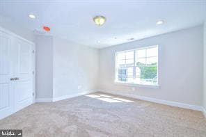 unfurnished bedroom featuring recessed lighting, baseboards, and carpet floors