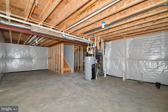 unfinished below grade area with stairway and gas water heater