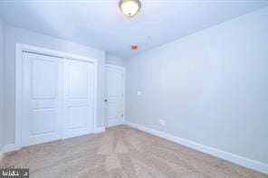 unfurnished bedroom featuring a closet and baseboards