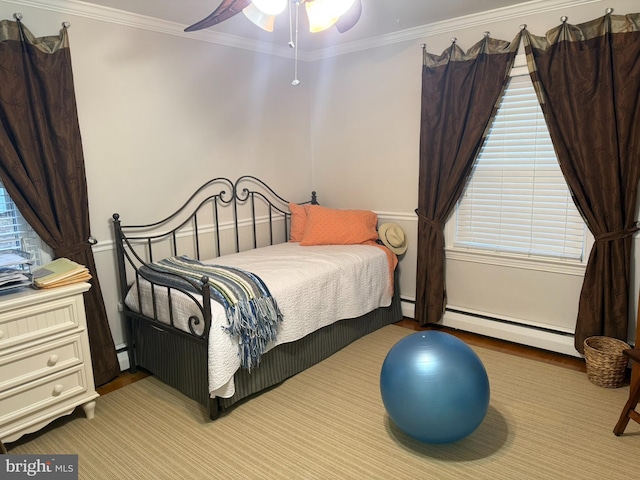 bedroom with a baseboard heating unit, a ceiling fan, baseboard heating, and ornamental molding