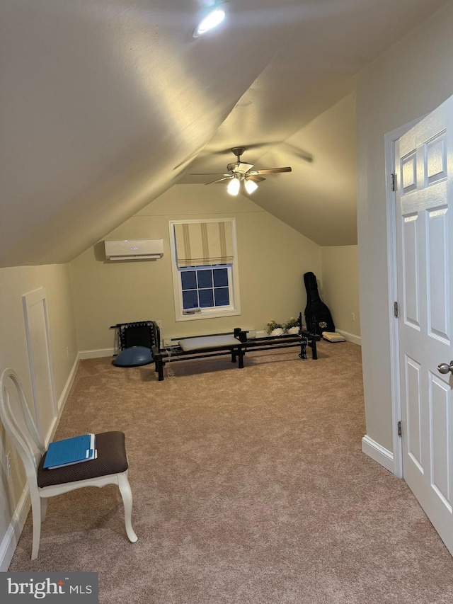 exercise room featuring a wall mounted air conditioner, baseboards, lofted ceiling, and carpet flooring