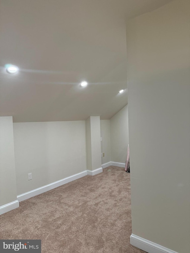 basement featuring recessed lighting, baseboards, and carpet