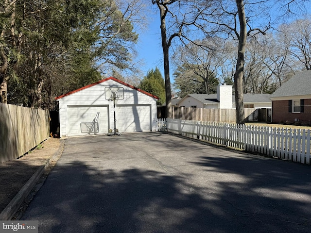 detached garage featuring fence