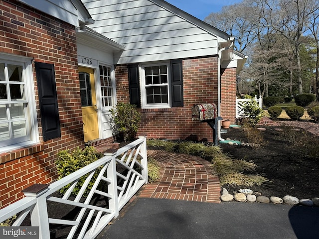 property entrance featuring brick siding