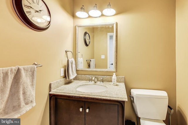 half bathroom featuring toilet and vanity