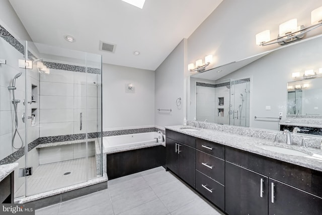 bathroom with visible vents, a shower stall, a garden tub, and a sink