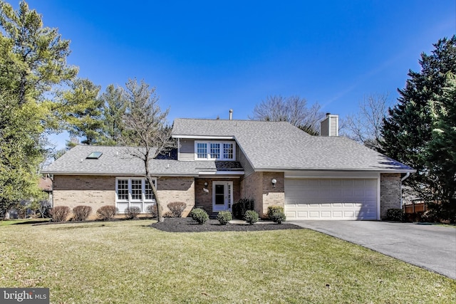 view of front of home with driveway, a front lawn, an attached garage, brick siding, and a chimney