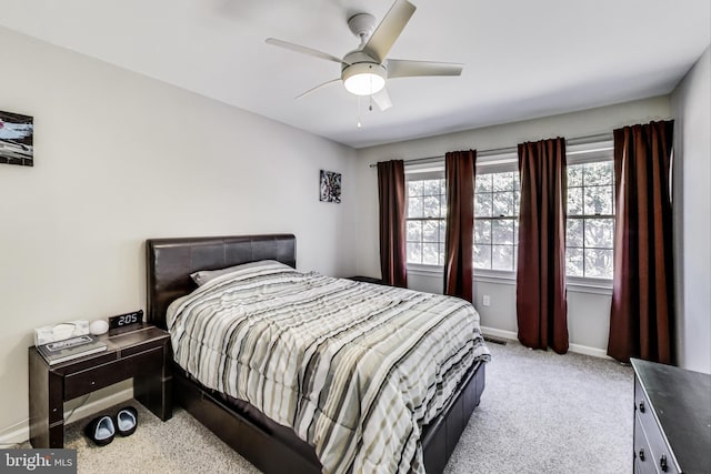 bedroom featuring light carpet, visible vents, a ceiling fan, and baseboards