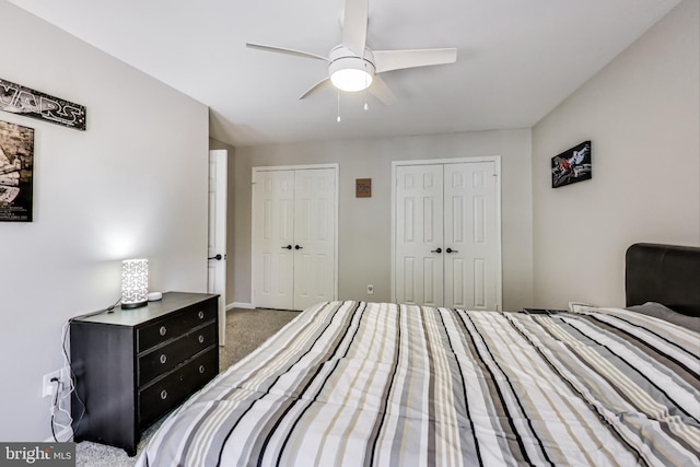 bedroom featuring carpet, baseboards, two closets, and ceiling fan