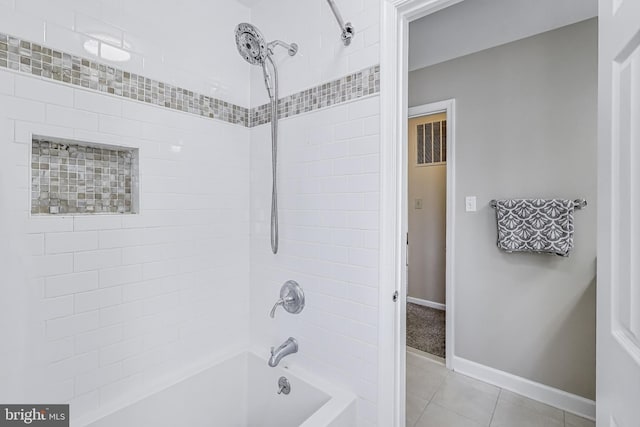 bathroom featuring bathtub / shower combination, baseboards, and tile patterned flooring