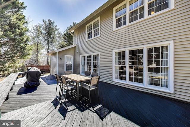 deck with outdoor dining area