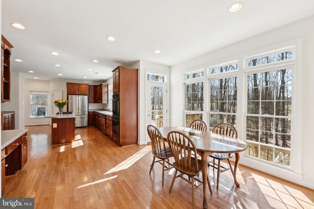 dining area featuring recessed lighting and light wood-style floors