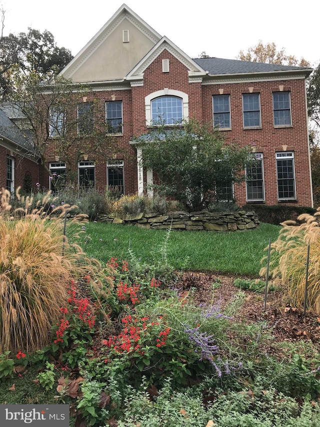 colonial-style house featuring brick siding