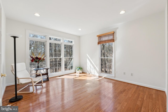 unfurnished room featuring recessed lighting, wood finished floors, and baseboards