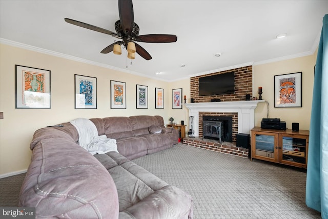 carpeted living room featuring ceiling fan, baseboards, a fireplace, and crown molding