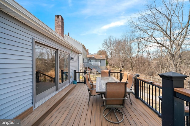 wooden terrace featuring outdoor dining area